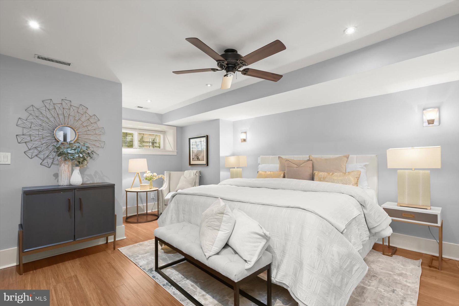2128 1st Street Northwest, Unit 1 Washington, DC 20001 - Photo 24 of 36 a bedroom with a bed and wooden floor