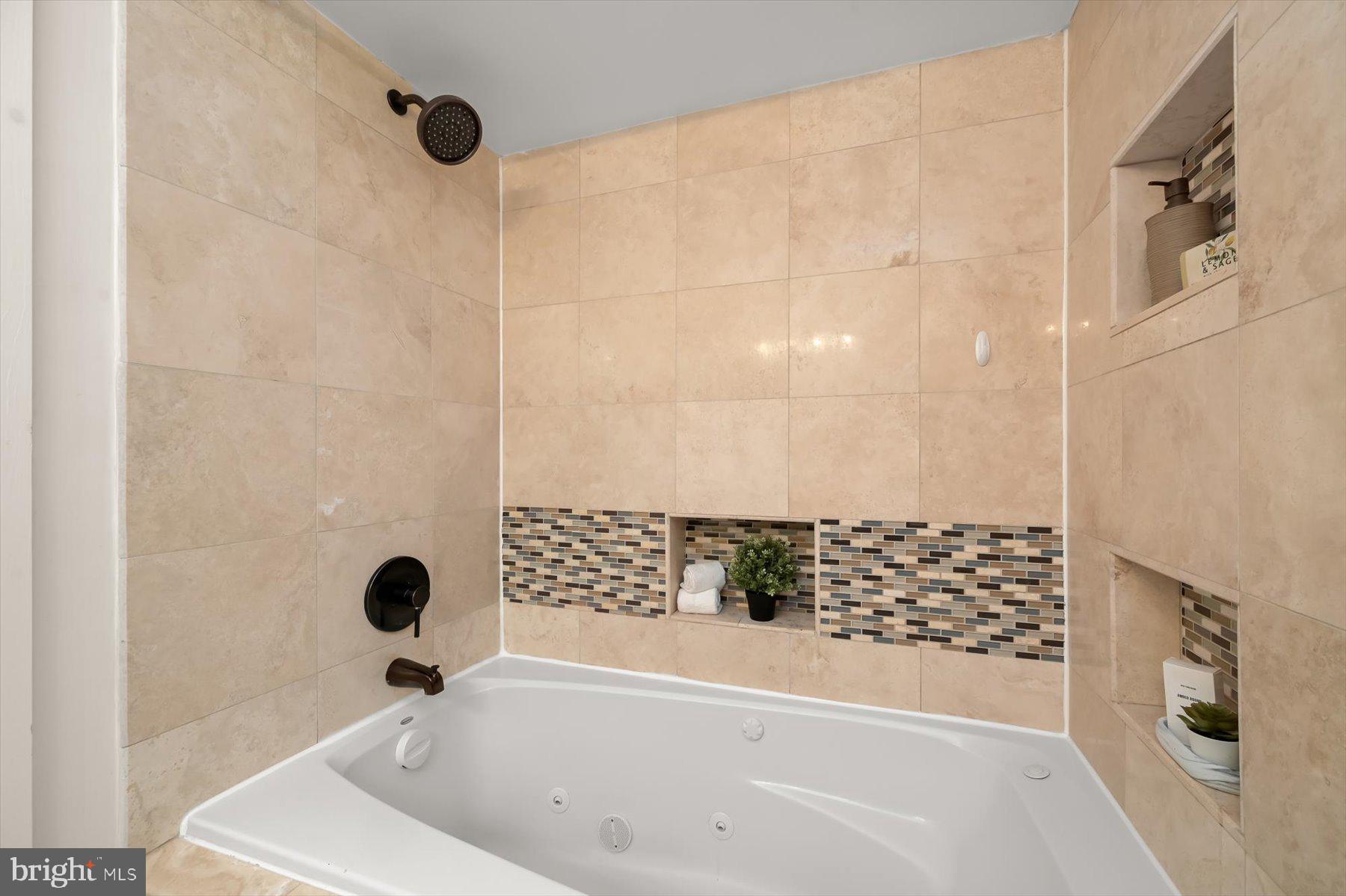 2128 1st Street Northwest, Unit 1 Washington, DC 20001 - Photo 27 of 36 a bathroom with a bathtub and shower