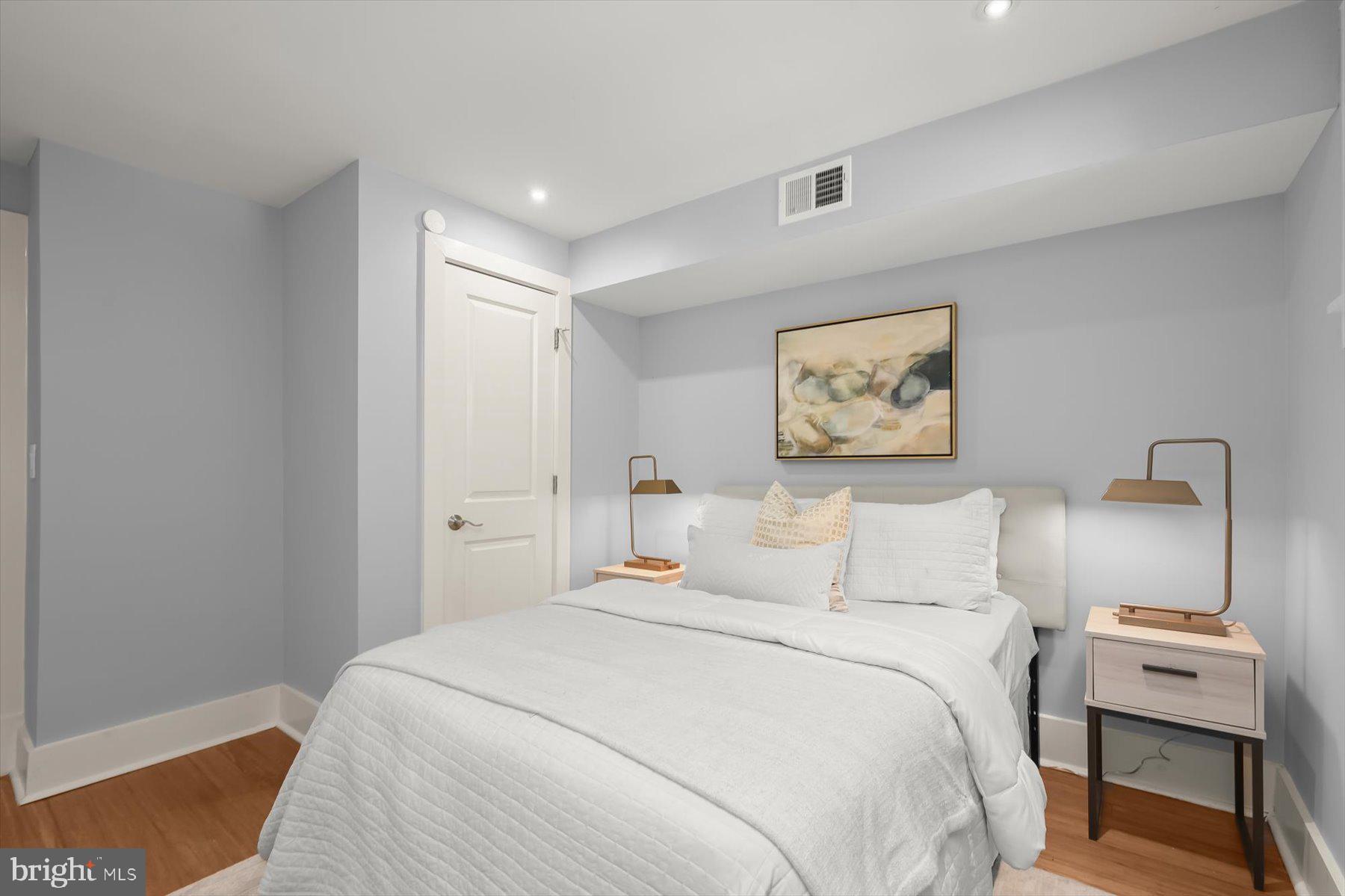 2128 1st Street Northwest, Unit 1 Washington, DC 20001 - Photo 28 of 36 a bedroom with a bed and a lamp