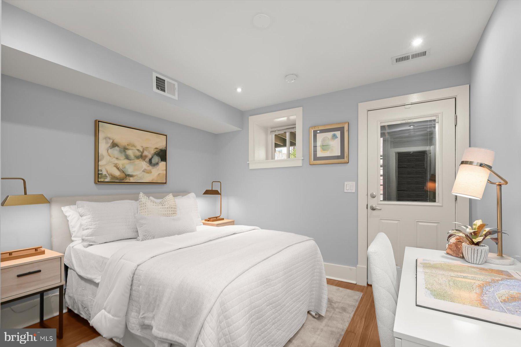 2128 1st Street Northwest, Unit 1 Washington, DC 20001 - Photo 29 of 36 a bedroom with a bed and a couch