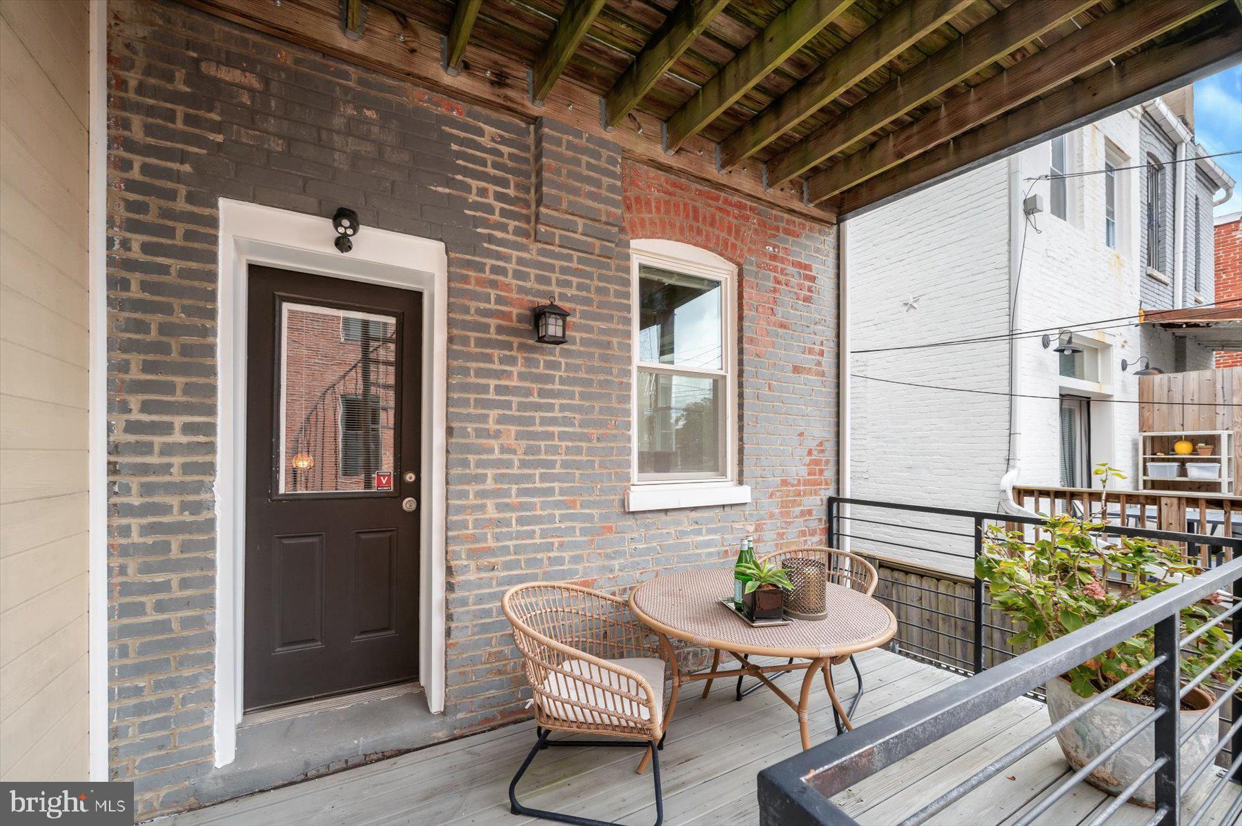 2128 1st Street Northwest, Unit 1 Washington, DC 20001 - Photo 32 of 36 a balcony with table and chairs