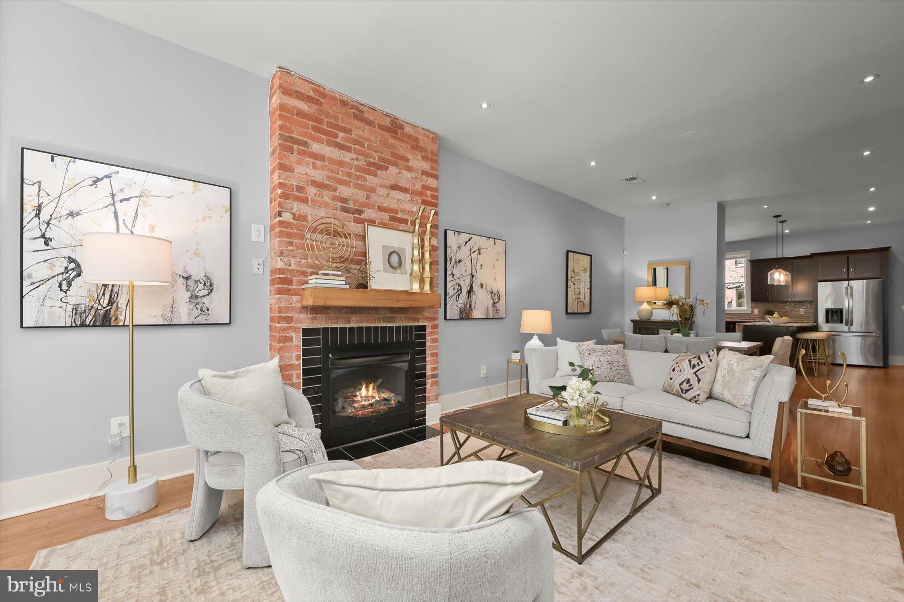2128 1st Street Northwest, Unit 1 Washington, DC 20001 - Photo 4 of 36 a living room with furniture dining table and a fireplace