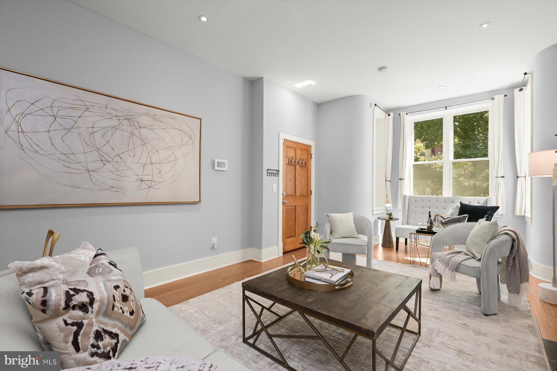 2128 1st Street Northwest, Unit 1 Washington, DC 20001 - Photo 5 of 36 a living room with furniture and a large window
