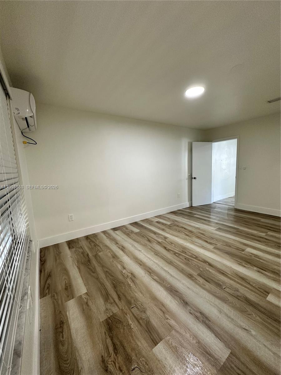 111 Southwest 31st Court Miami, FL 33135 - Photo 12 of 27 en empty room with wooden floor