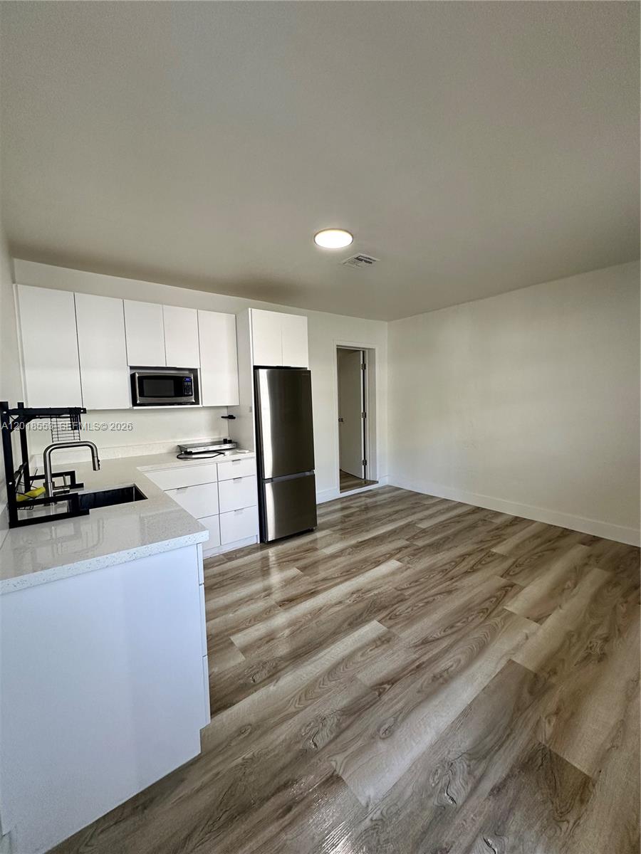 111 Southwest 31st Court Miami, FL 33135 - Photo 13 of 27 a kitchen with stainless steel appliances a refrigerator sink and microwave