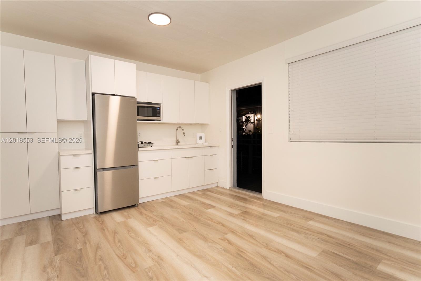 111 Southwest 31st Court Miami, FL 33135 - Photo 21 of 27 a kitchen with a refrigerator sink and cabinets