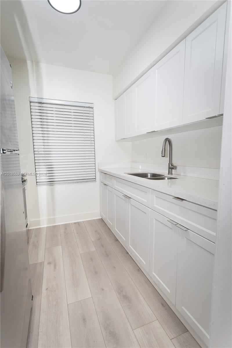 111 Southwest 31st Court Miami, FL 33135 - Photo 4 of 27 a bathroom with a sink and a mirror