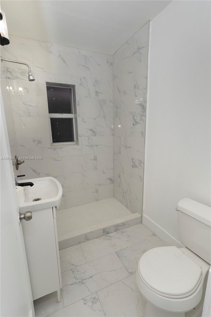 111 Southwest 31st Court Miami, FL 33135 - Photo 5 of 27 a bathroom with a toilet a sink and bathtub