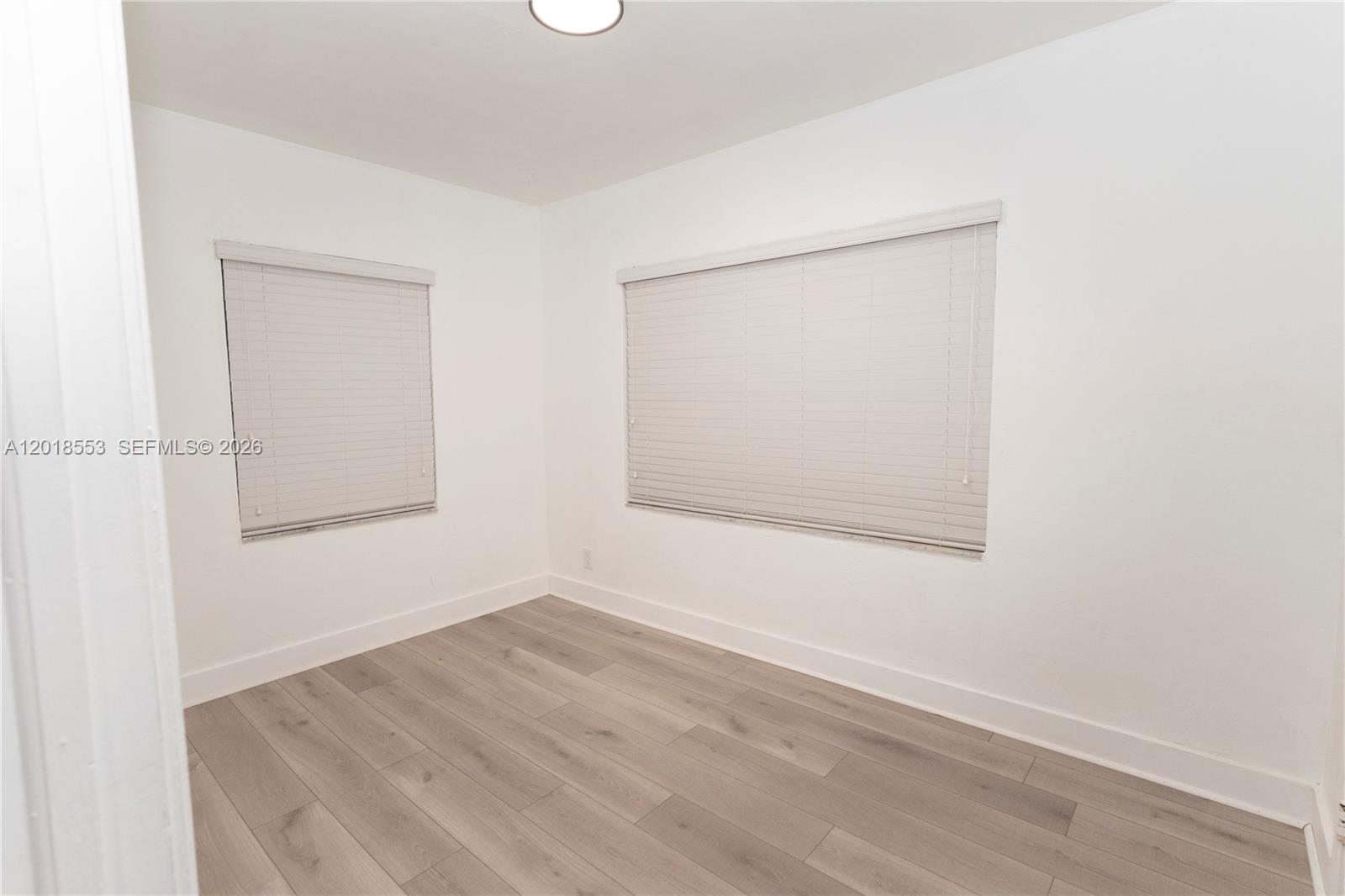 111 Southwest 31st Court Miami, FL 33135 - Photo 8 of 27 an empty room with a window