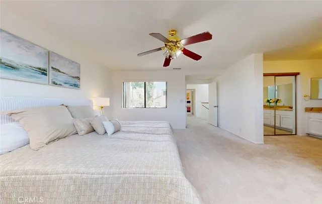 a bedroom with a large bed and a chandelier