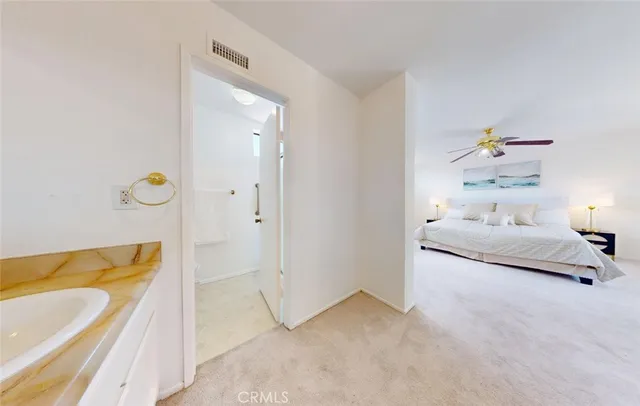 a spacious bedroom with a bed and a couch