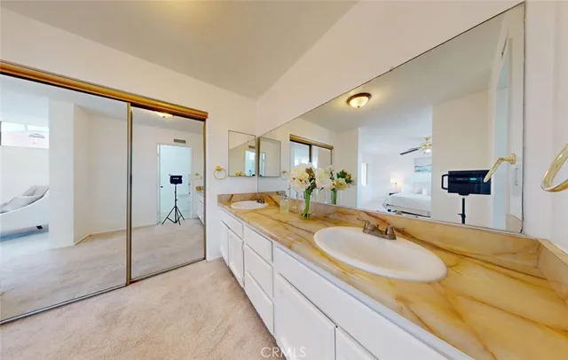 a spacious bathroom with a granite countertop sink mirror and shower