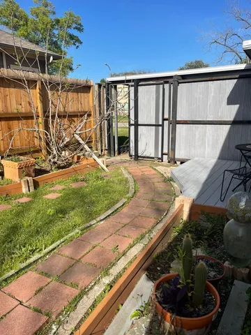 a view of a backyard with plants and a patio