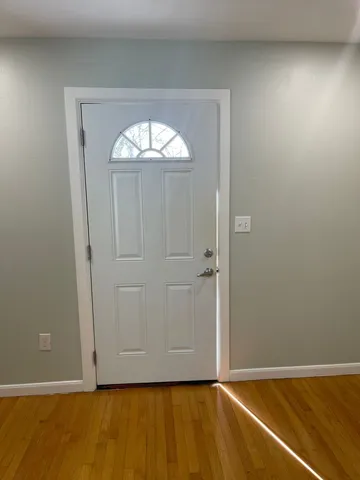 an empty room with wooden floor and closet