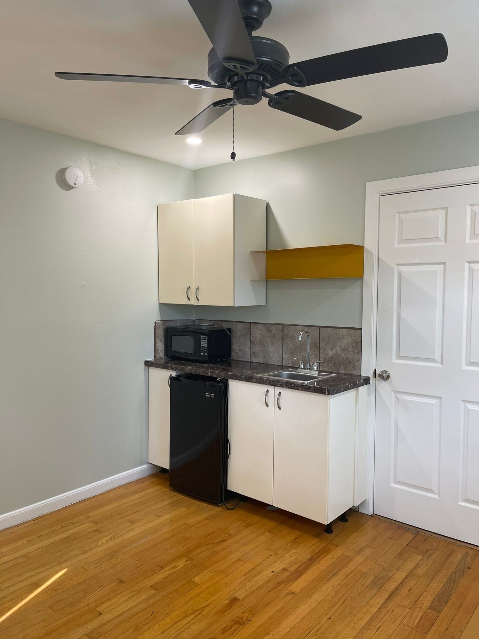 3102 Jarvis Street, Unit 2 Houston, TX 77063 - Photo 4 of 15 a kitchen with a wooden floor and a refrigerator