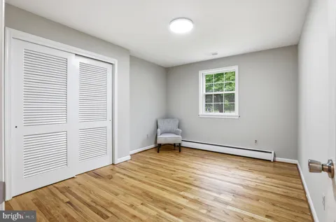 a view of a room with wooden floor and bedroom