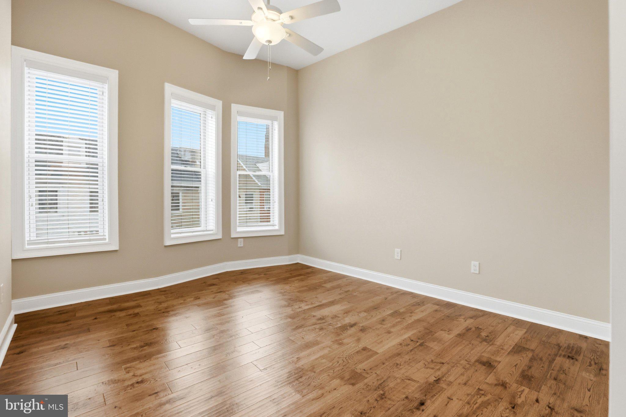 222 South Exeter Street Baltimore, MD 21202 - Photo 15 of 41 a view of an empty room with wooden floor and a window
