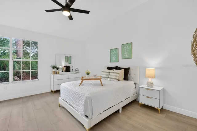 a view of a room with wooden floor and a ceiling fan