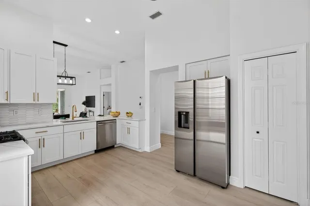 a view of a dining room with furniture a rug and wooden floor