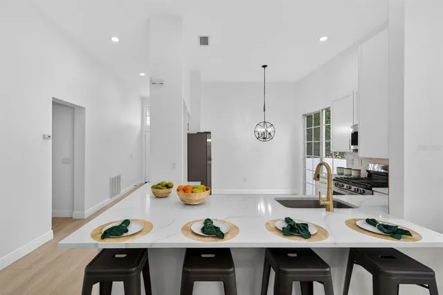 a living room with furniture a dining table and a flat screen tv