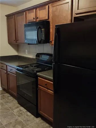 a kitchen with stainless steel appliances granite countertop a stove and a microwave