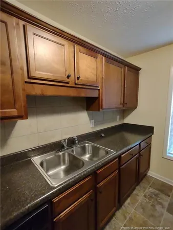 a kitchen that has a sink and cabinets