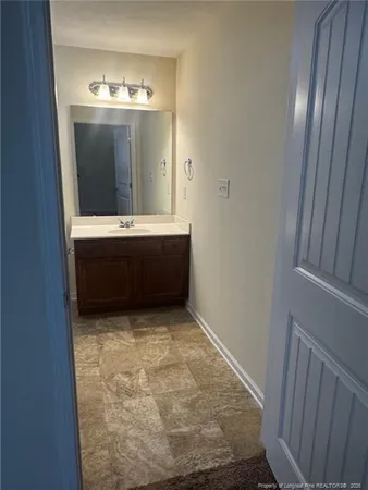 a view of room with granite countertop sink and mirror