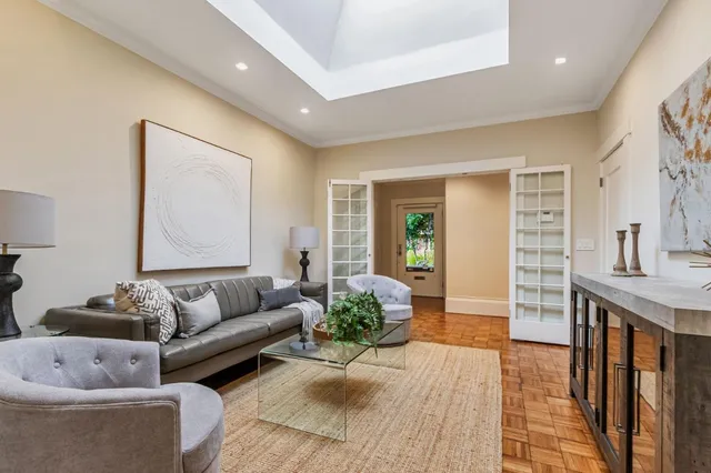 a spacious bedroom with a bed and glass door