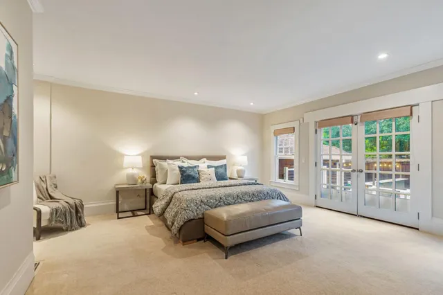 a bedroom with a large bed and a chandelier