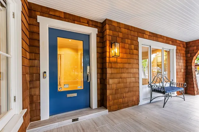 a view of front door with chair and table