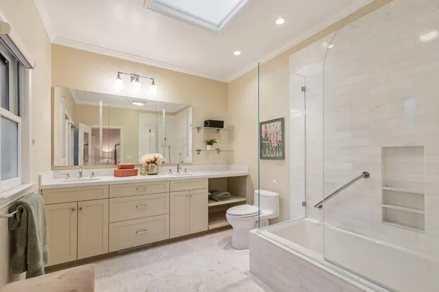 a bedroom with a bed and large windows