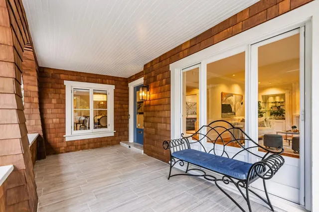 a living room with furniture and floor to ceiling windows