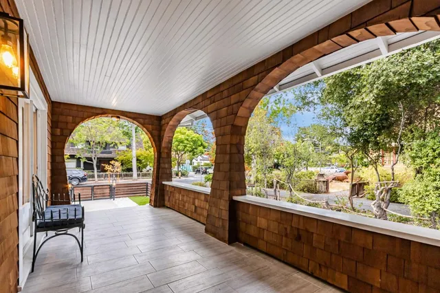 a living room with furniture fireplace and a large window
