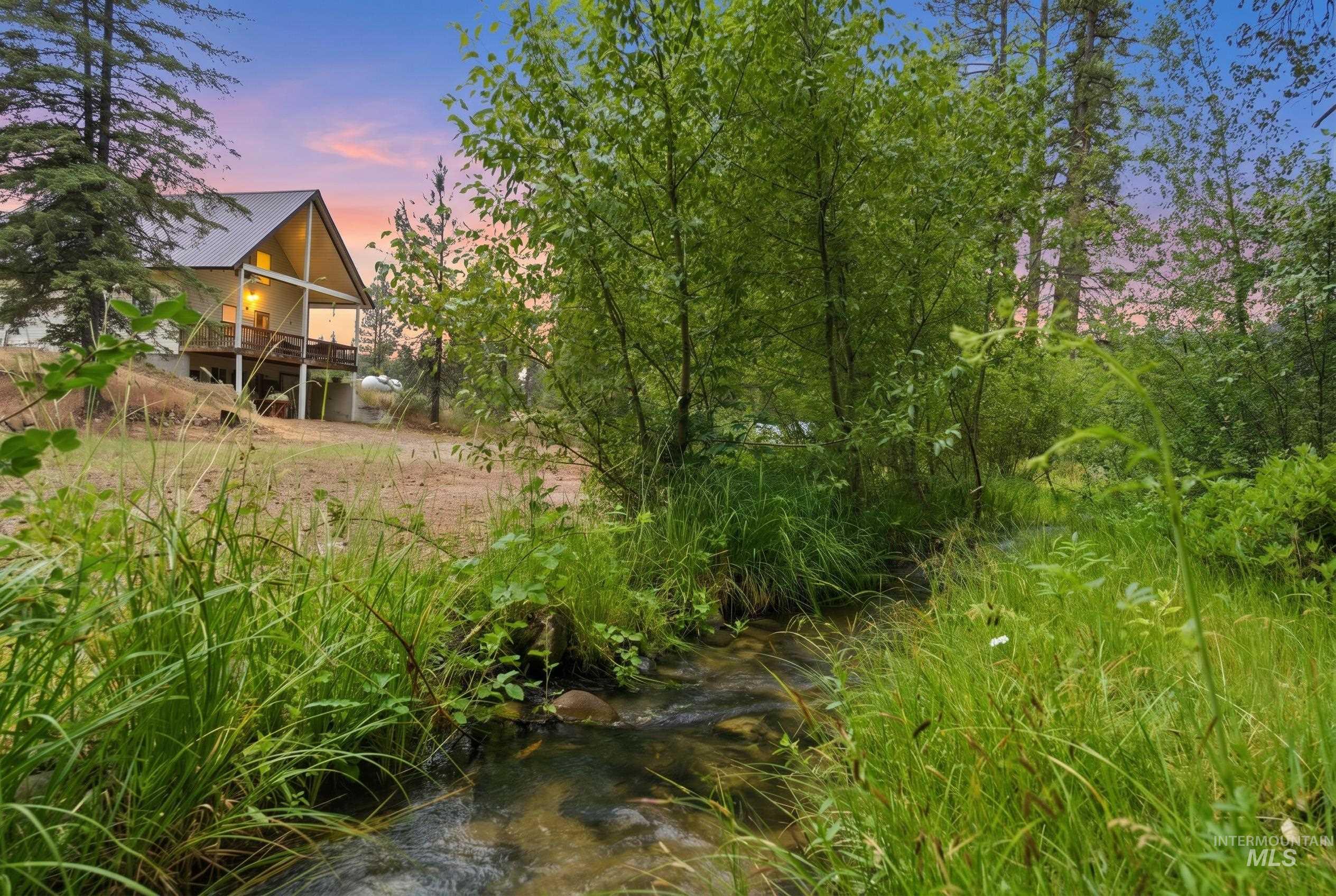 3980 North Pine-Featherville Road Mountain Home, ID 83647 - Photo 7 of 35 Natural stream winding through lush green foliage