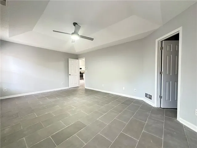 a view of an empty room with a ceiling fan