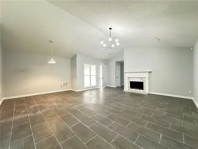 a view of an empty room with a fireplace