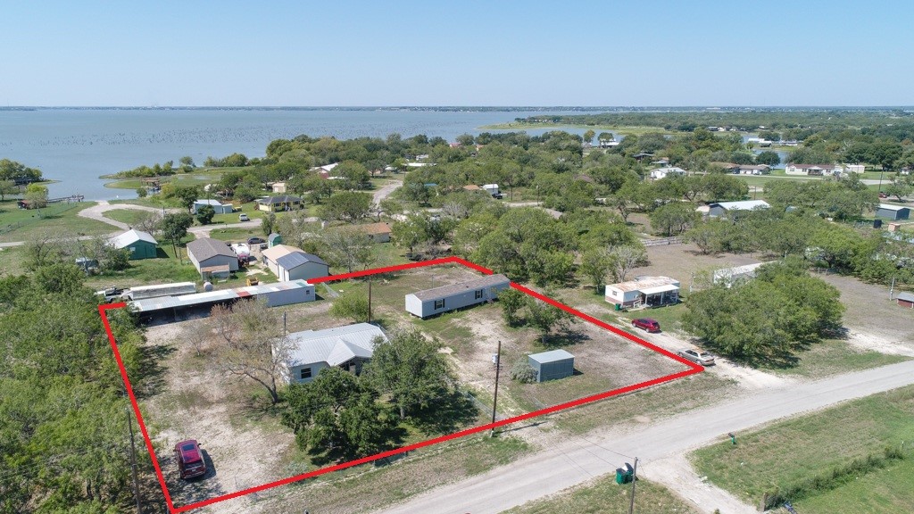 FRONT OF HOMES WITH GARAGES & WORKSHOP AT BACK OF