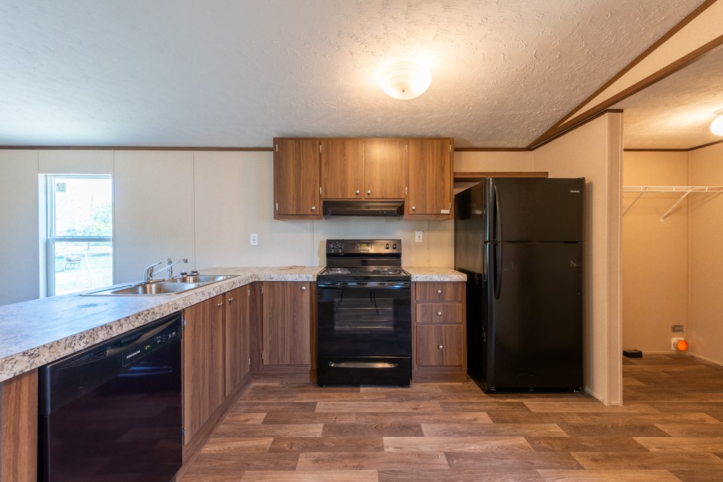 24731 County Road 340 Mathis, TX 78368 - Photo 17 of 40 a kitchen with stainless steel appliances granite countertop a refrigerator stove and sink