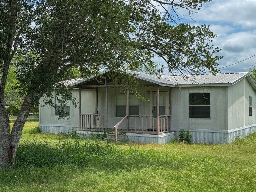 24731 County Road 340 Mathis, TX 78368 - Photo 2 of 40 a front view of a house with a yard