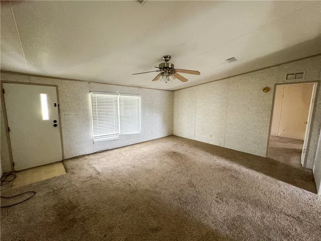 a view of an empty room with a window