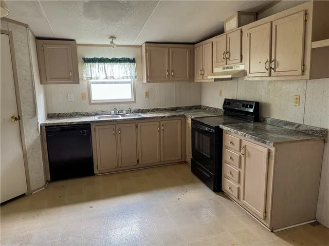 a kitchen with stainless steel appliances granite countertop a refrigerator stove and sink