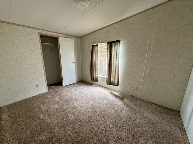 a bathroom with a granite countertop sink a toilet and a mirror