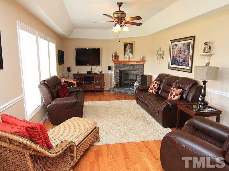 2200 Jim Latta Road Rougemont, NC 27572 - Photo 2 of 13 a living room with furniture a flat screen tv and a fireplace