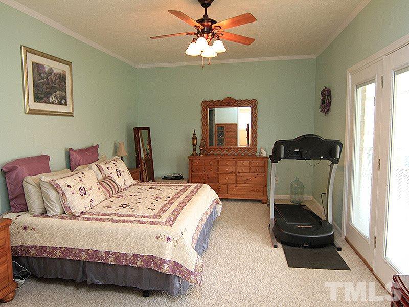 2200 Jim Latta Road Rougemont, NC 27572 - Photo 7 of 13 a bedroom with a bed and a chandelier