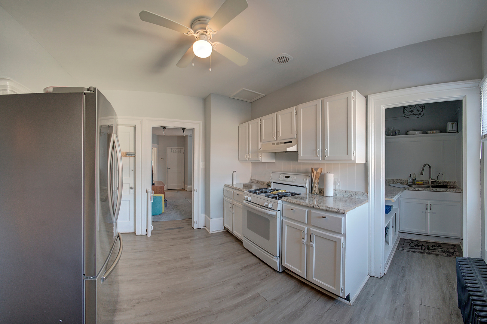 118 East 11th Street Lockport, IL 60441 - Photo 9 of 30 a kitchen with white cabinets and stainless steel appliances