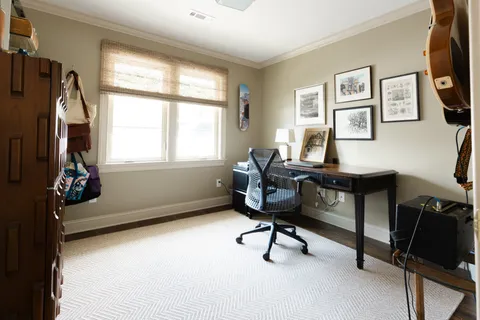 a view of a patio with a table and chairs and potted plants