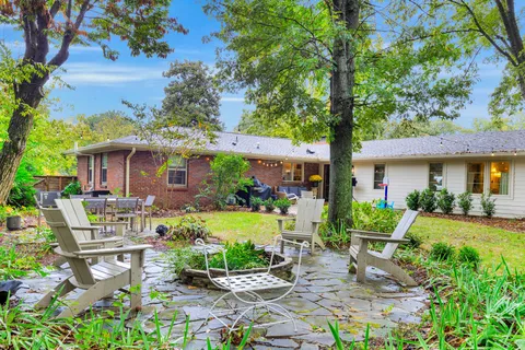 a front view of house with yard and green space