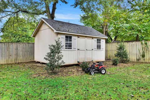 a backyard of a house with yard and outdoor seating