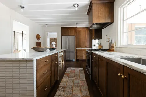 a kitchen with stainless steel appliances granite countertop a sink and a stove