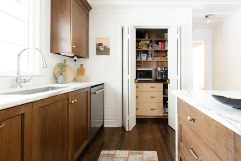 a spacious bathroom with double vanity and a mirror